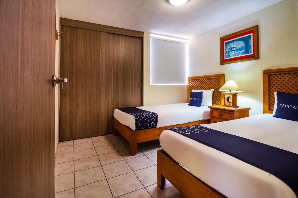 Postel nebo postele na pokoji v ubytování Suites Navata