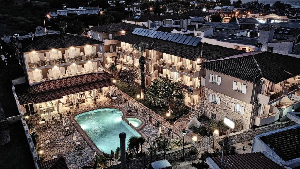 an aerial view of a building with a swimming pool at night at Sarantis Hotel in Hanioti