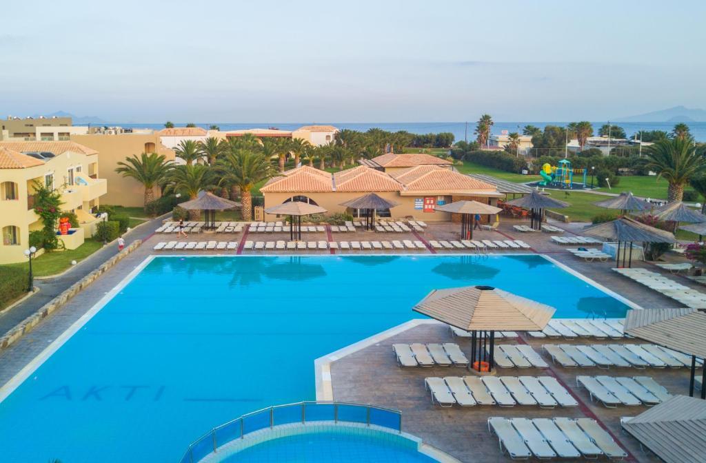 una vista aérea de una piscina con sillas y sombrillas en Akti Beach Club en Kardámaina