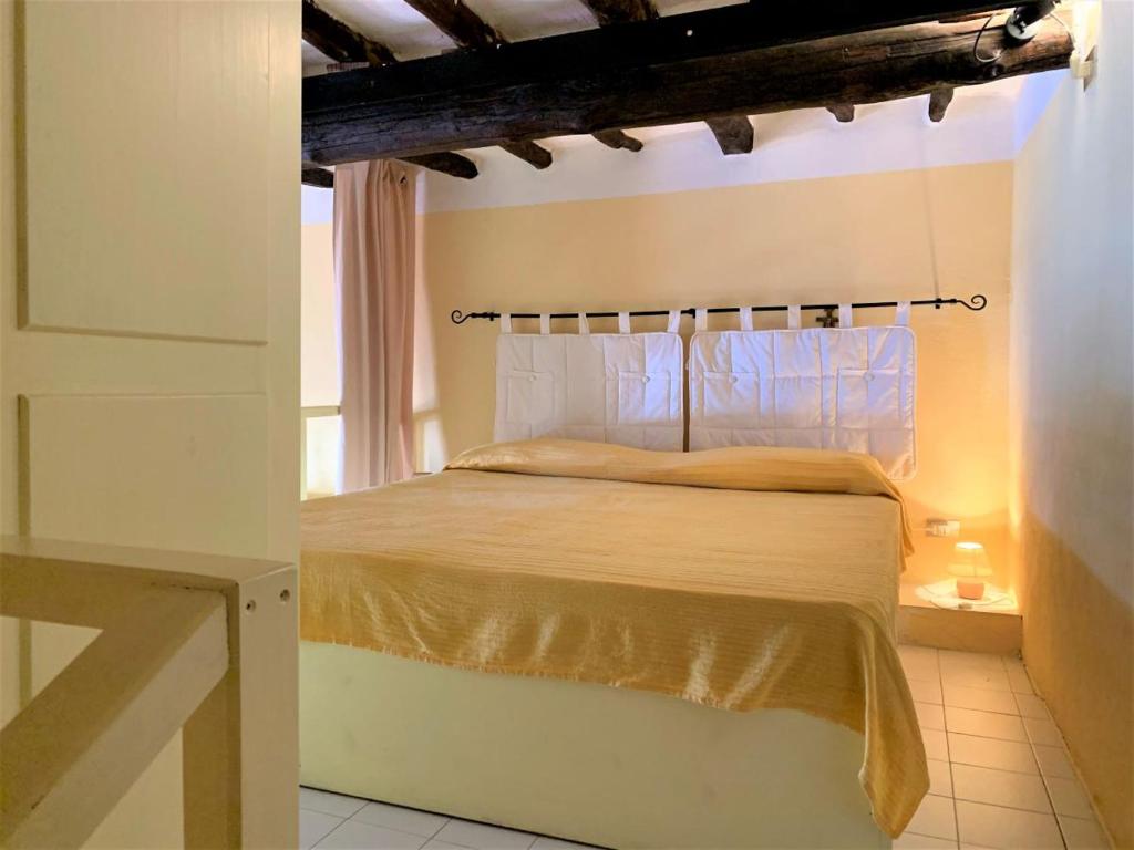 Postel nebo postele na pokoji v ubytování Casa Papuzza e Casa Lucilla