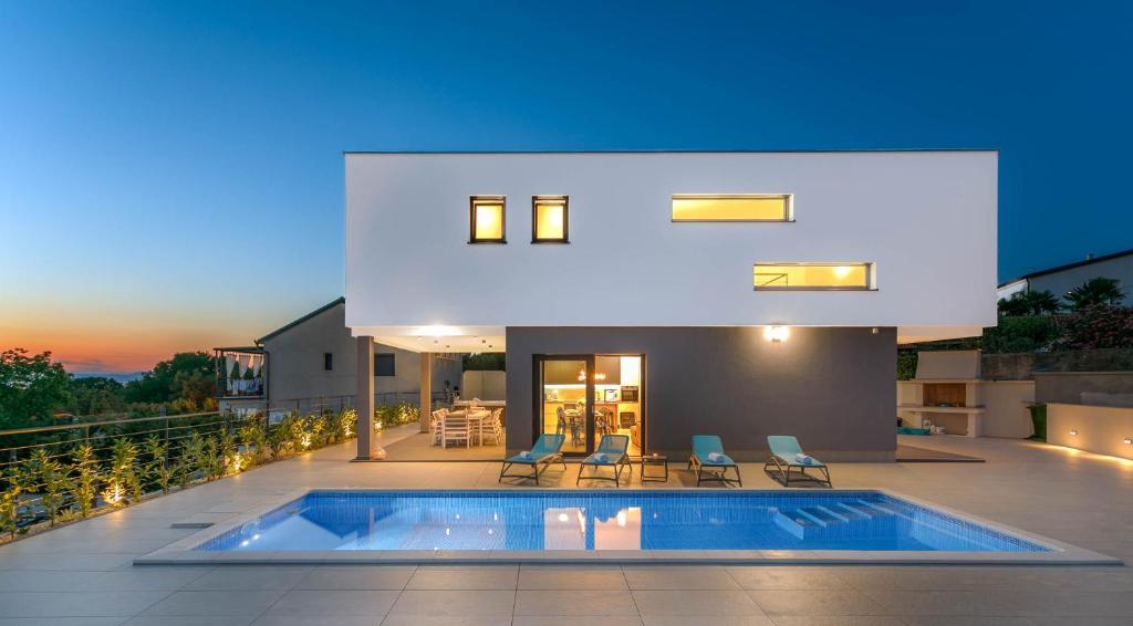a house with a swimming pool on a roof at Villa LEA MAGDALENA in Malinska