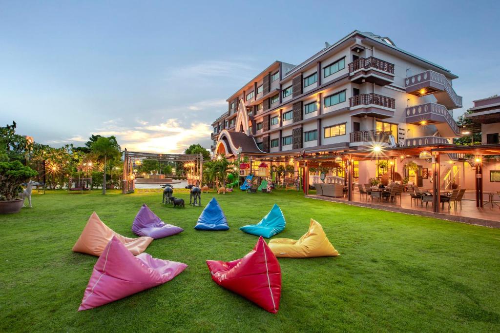 un grupo de cometas de colores en la hierba frente a un edificio en Phanomrungpuri Hotel Buriram en Nang Rong