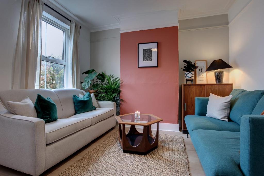 a living room with a couch and a table at Ideal for contractors discounted longer stays Designer city centre home with free parking in Norwich