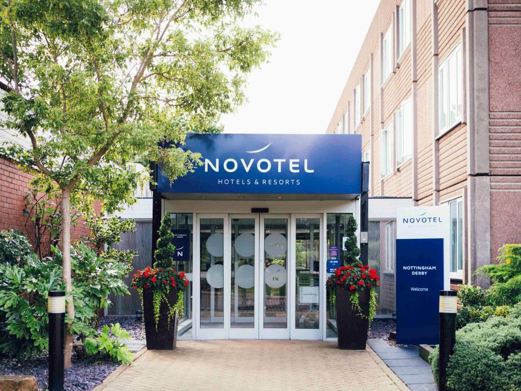 a blue building with a sign on the front of it at Novotel Nottingham Derby in Long Eaton