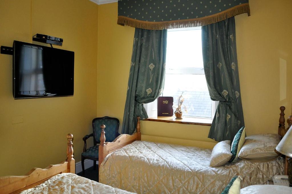 Postel nebo postele na pokoji v ubytování Highfield House Guesthouse