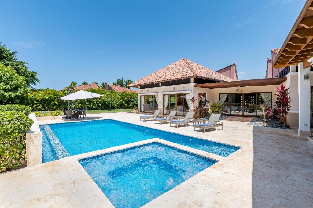 a swimming pool in the backyard of a house at Stunning Villa with Private Pool and Jacuzzi in Casa de Campo in La Romana