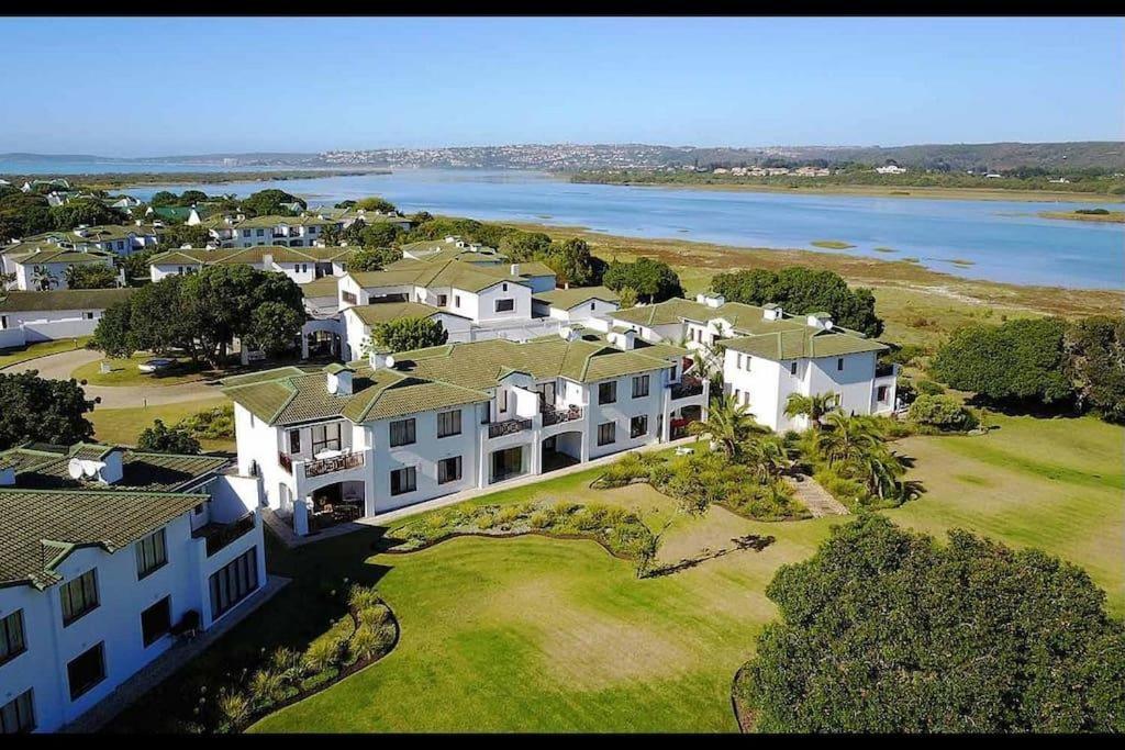 an aerial view of a large house next to the water at Keurbooms River Apartment in Plettenberg Bay