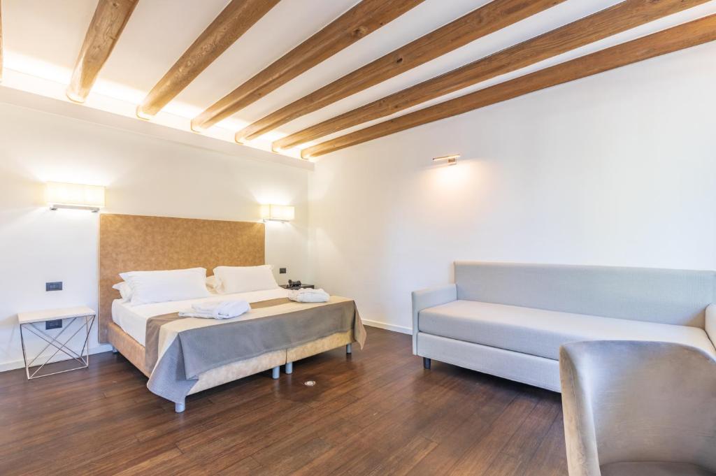 A bed or beds in a room at Raphael Hotel Arbatax