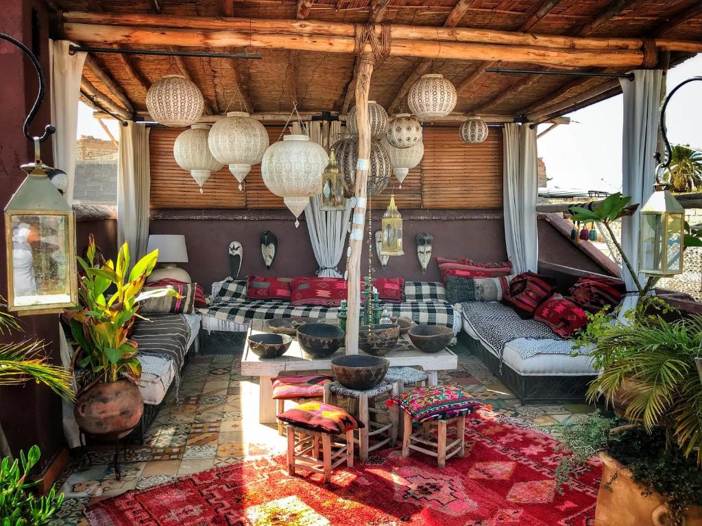 a living room with a couch and a table at Riad Chocolat in Marrakesh