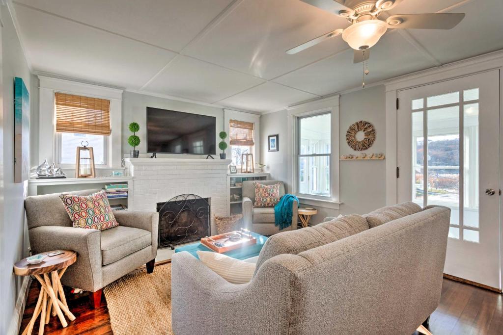 a living room with a couch and chairs and a fireplace at Cozy Coastal Cottage 5 Mi to Narragansett Beach! in Narragansett