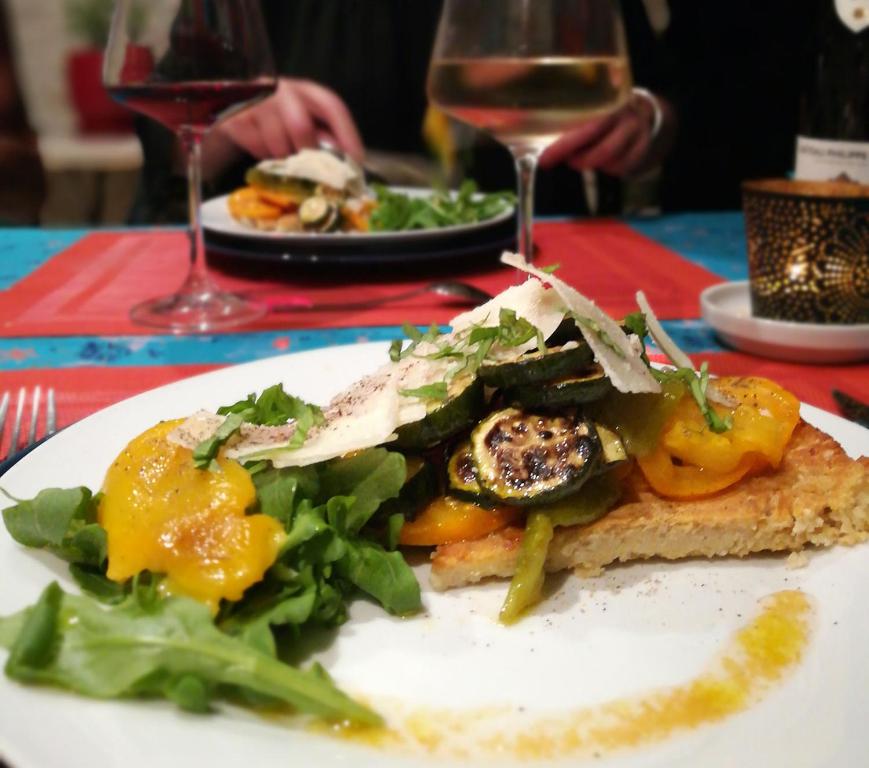 a plate of food with a salad on a table at Le Clos des Chênes in Lagarde-Paréol