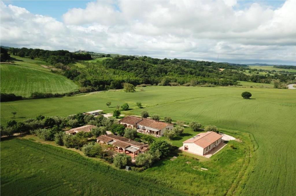 an aerial view of a house in a green field at Bio Agriturismo Le Cascatelle in Saturnia