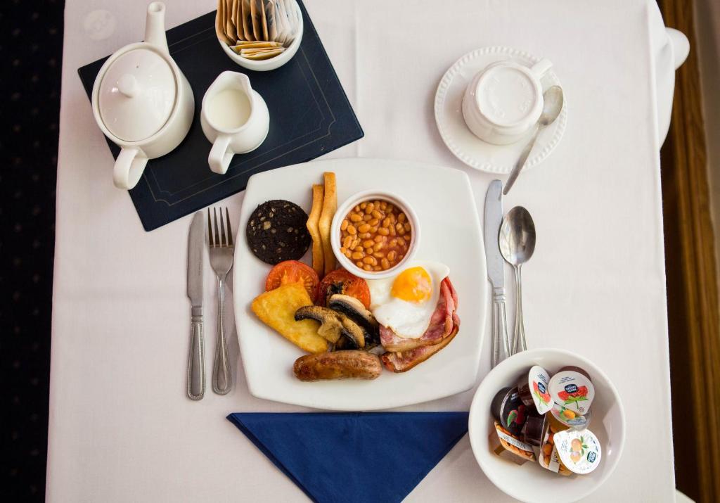 a white table topped with a plate of breakfast food at Yelf's Hotel in Ryde