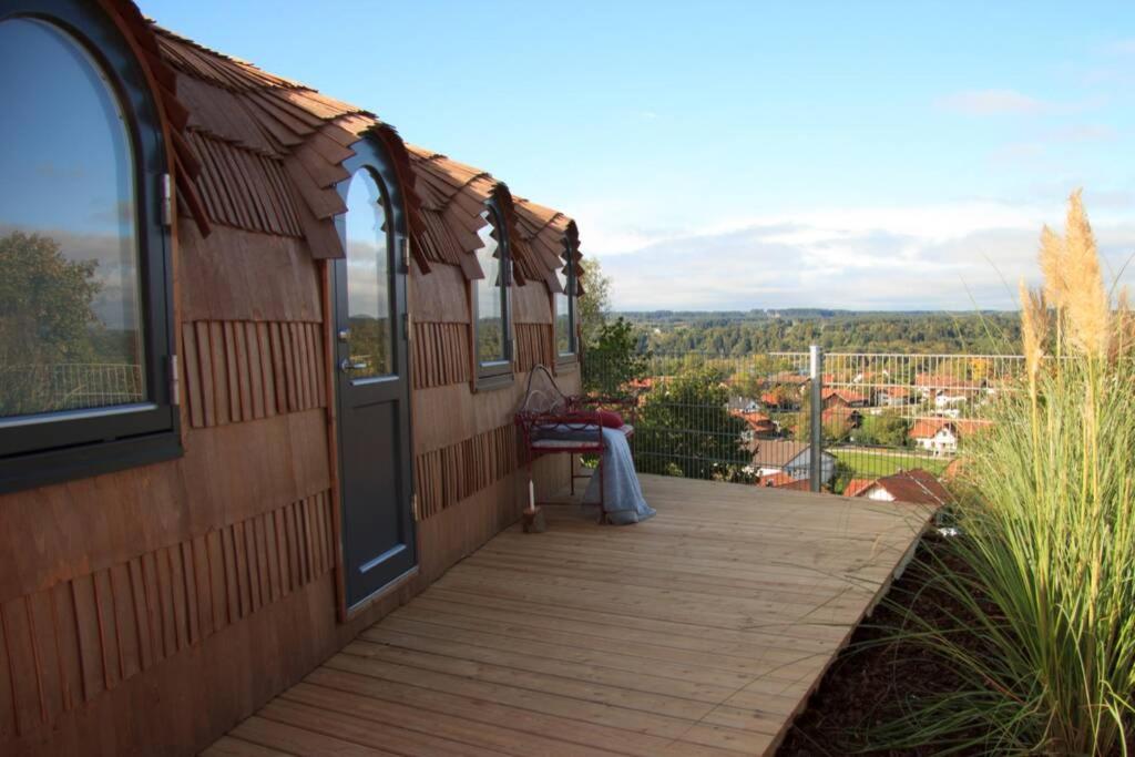 a wooden deck with a view of a city at Schmidis Igluhuts im Pfaffenwinkel - Tiny House 1 in Apfeldorf