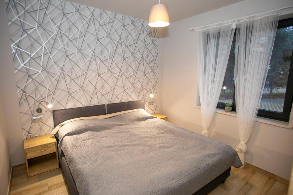 Postel nebo postele na pokoji v ubytování Apartamenty PIER