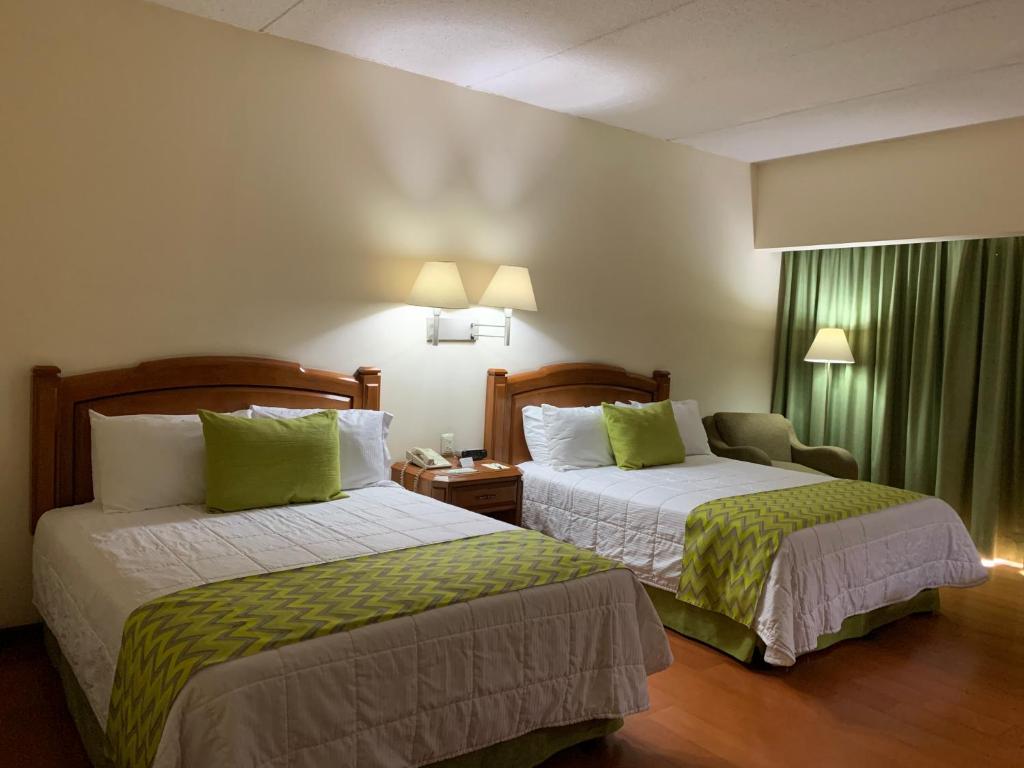 Voodi või voodid majutusasutuse Hotel Villa Florida Puebla toas