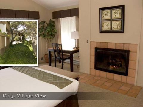 a living room with a bed and a fireplace at Adobe Inn in Carmel