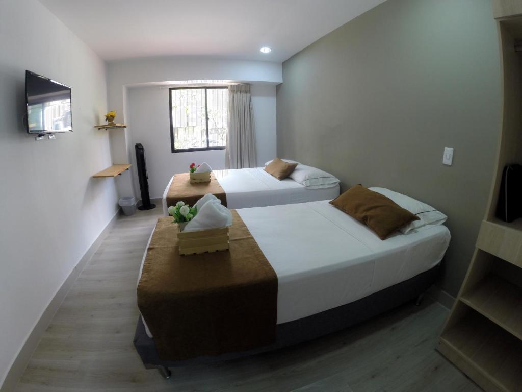 Postel nebo postele na pokoji v ubytování Hotel Boutique Plaza