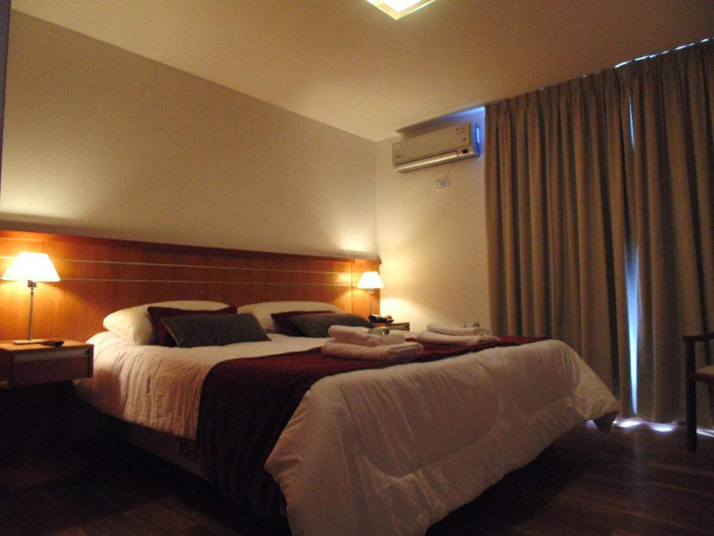 Кровать или кровати в номере Catamarca Suites Land