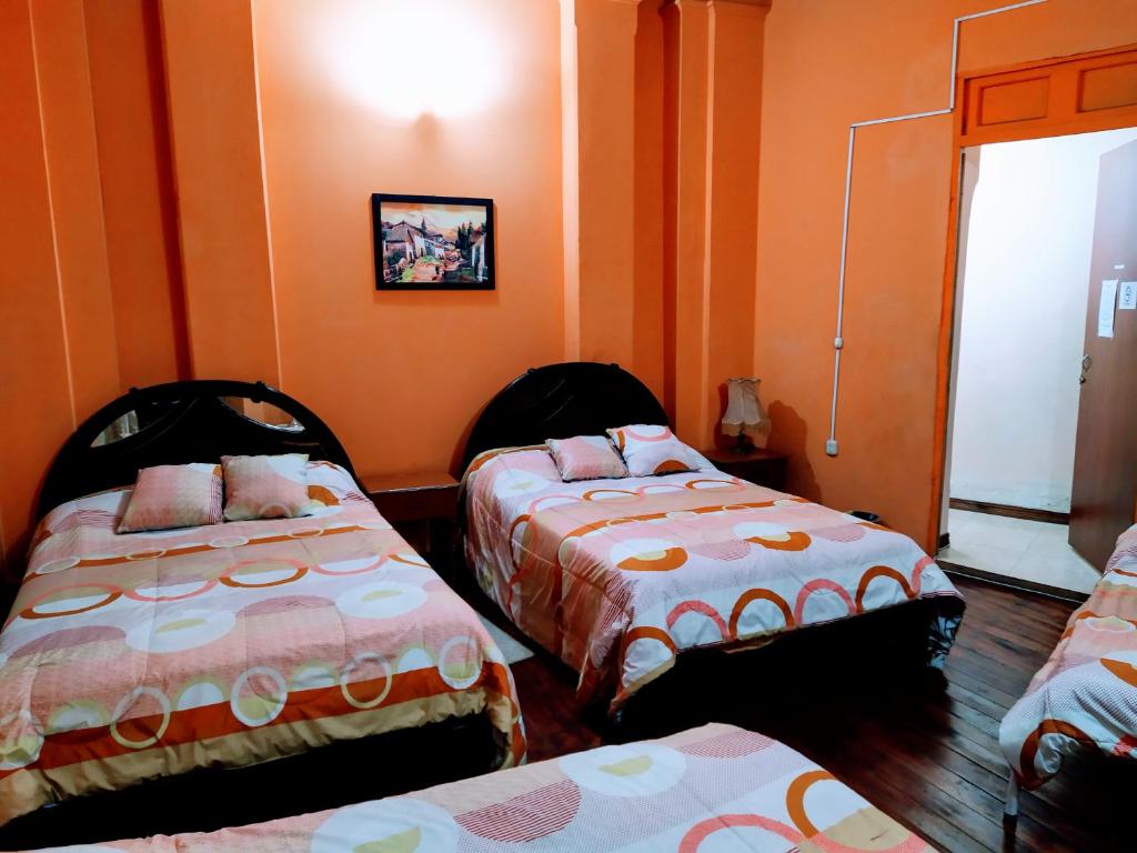 Postel nebo postele na pokoji v ubytování Hostal Latitud Ecuem