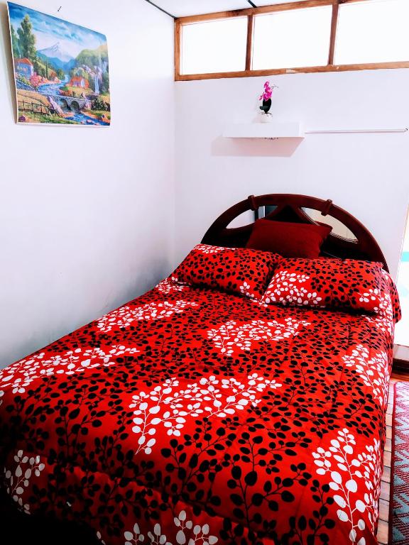 Postel nebo postele na pokoji v ubytování Hostal Latitud Ecuem