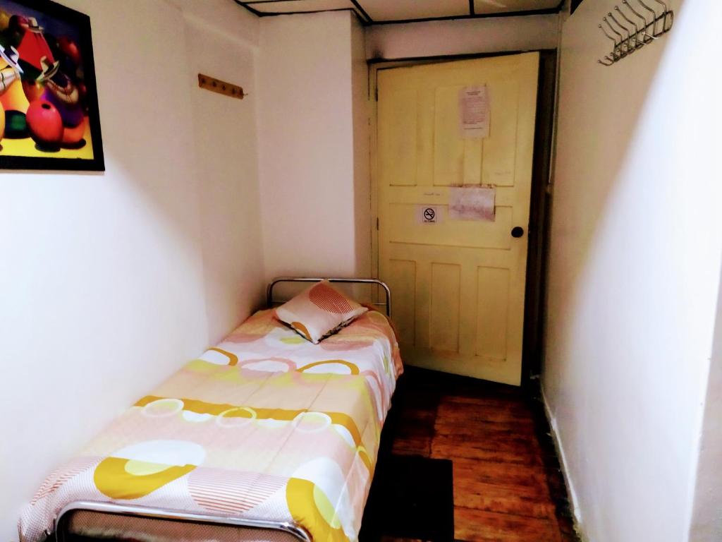 Postel nebo postele na pokoji v ubytování Hostal Latitud Ecuem