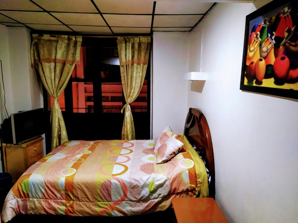 Postel nebo postele na pokoji v ubytování Hostal Latitud Ecuem