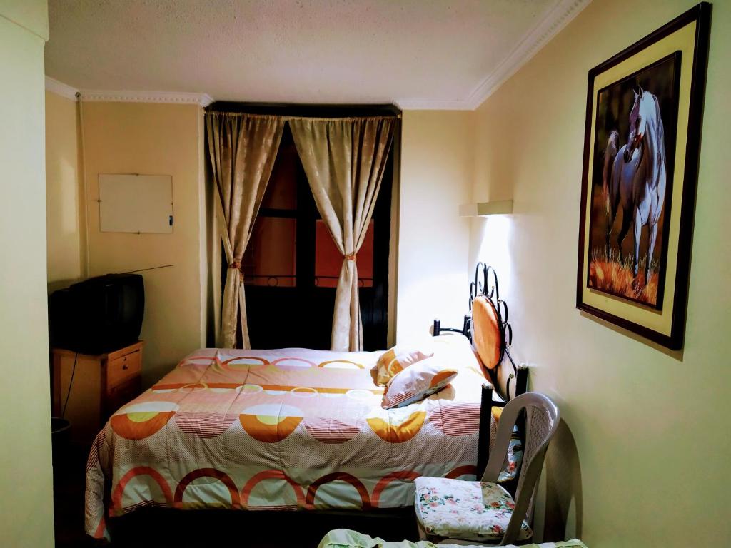 Postel nebo postele na pokoji v ubytování Hostal Latitud Ecuem