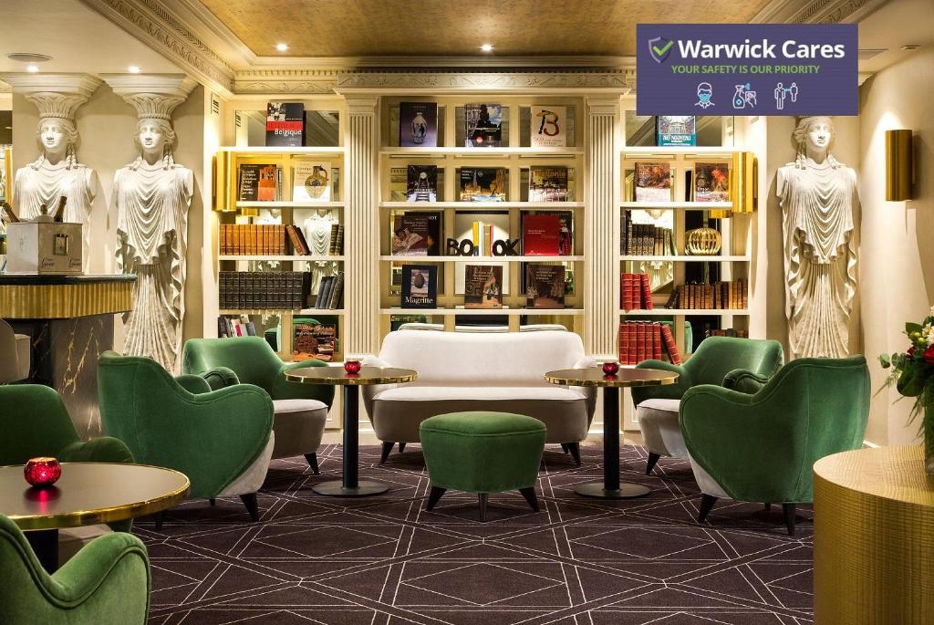 a waiting room with green chairs and tables at Hotel Barsey by Warwick in Brussels