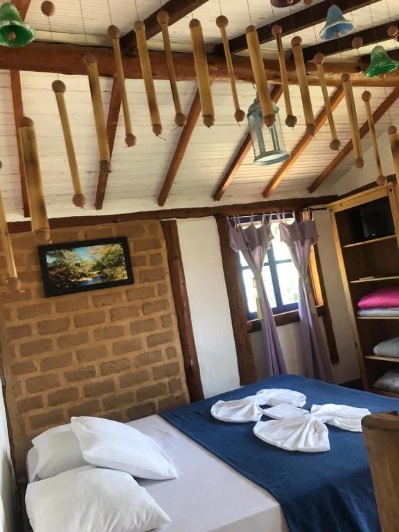 Postel nebo postele na pokoji v ubytování Pousada Villa Cachoeira
