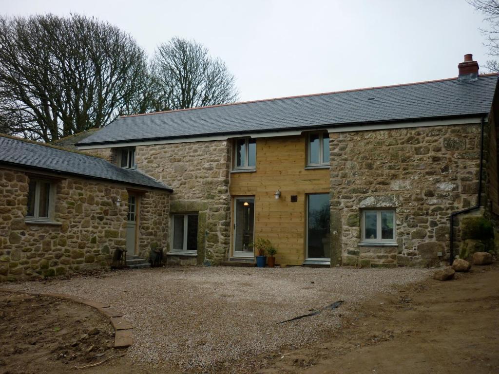 a stone house with a driveway in front of it at Trevaylor Vean in Penzance