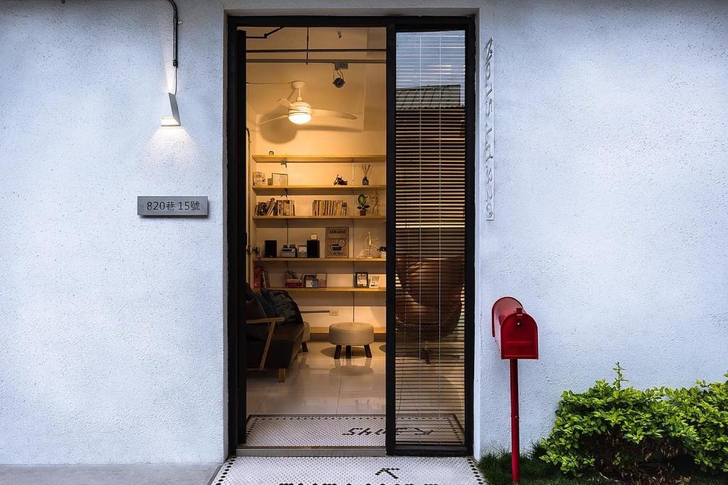 a door leading to a room with a table and a room at Tainan No 820 in Tainan