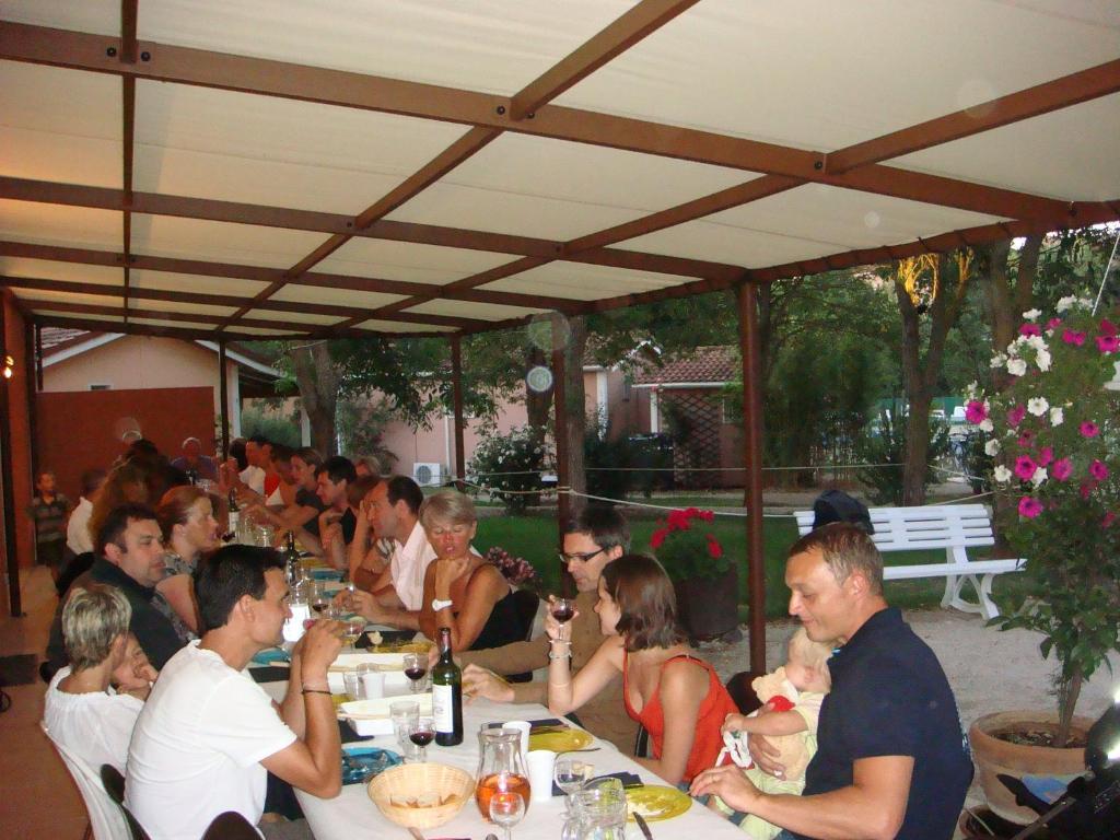 a group of people sitting at tables in a restaurant at Le Hameau des Genets in Montlaur