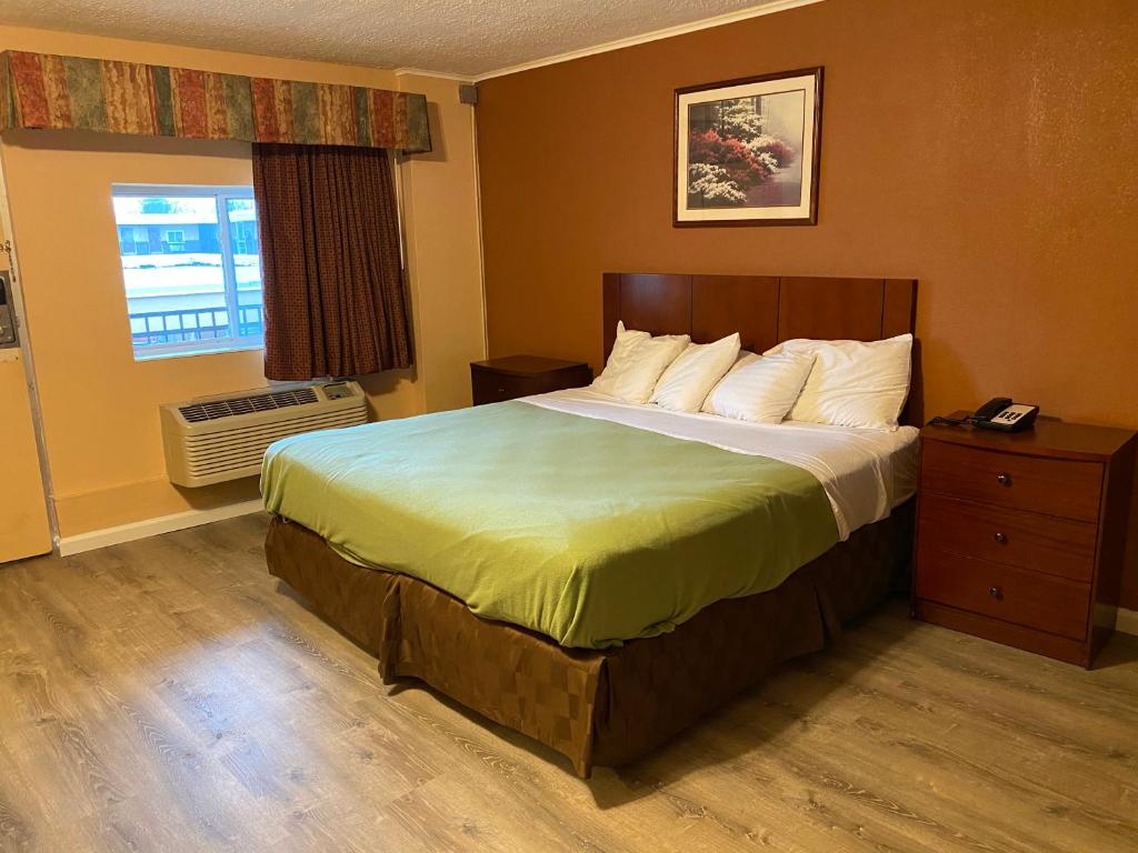 a hotel room with a bed and a window at Travel Inn in Broadview