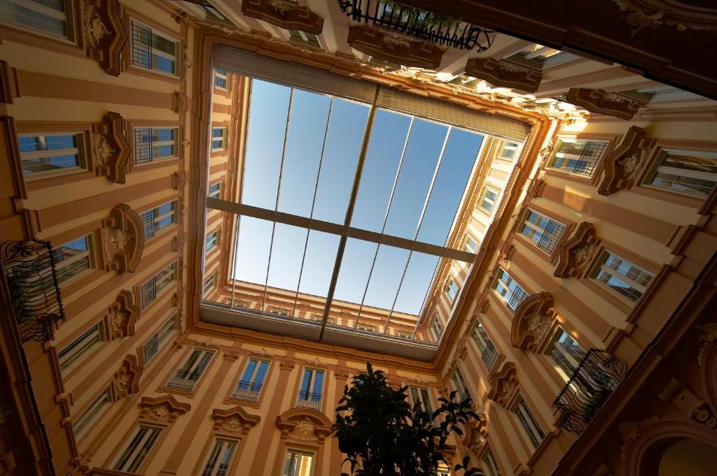 um quarto com uma grande janela num edifício em Grand Hotel Piazza Borsa em Palermo