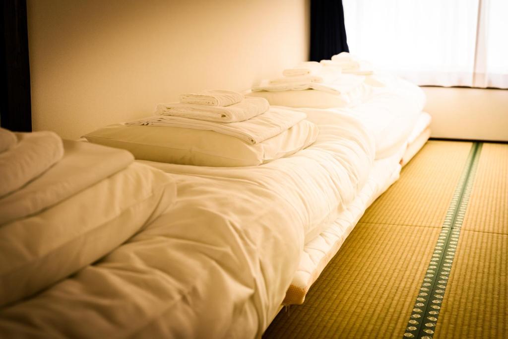 Postel nebo postele na pokoji v ubytování Biker's Inn Onomichi 自転車の宿おのみち supported by COCOSTAY