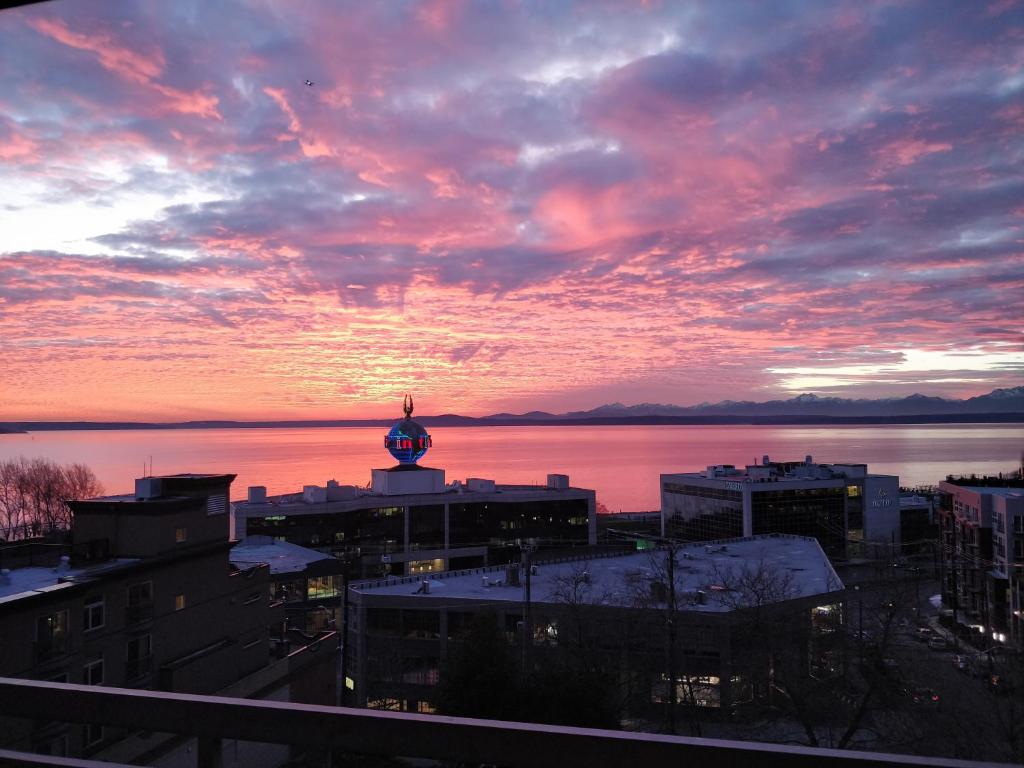 a view of a city with a sunset at Top Floor Water View Oasis near Space Needle & Cruise in Seattle