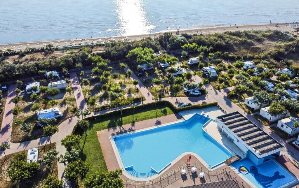 een luchtzicht op een resort met een zwembad en het strand bij Miramare Camping Village in Sottomarina