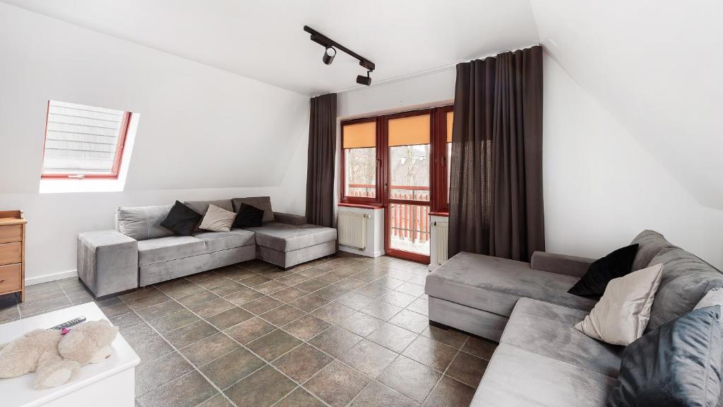a living room with two couches and a couch at Apartamenty Sun & Snow Centrum in Zakopane