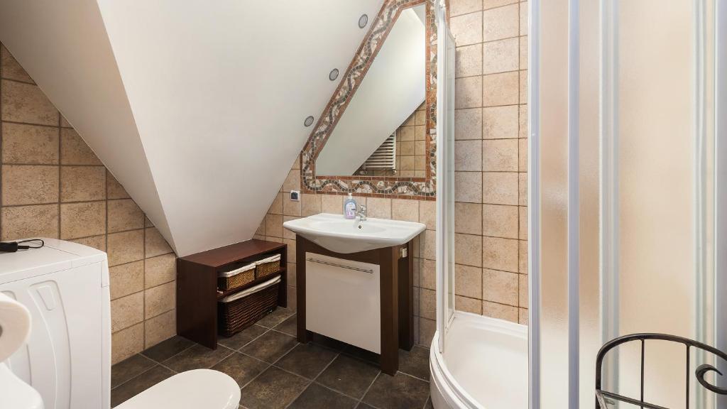 a bathroom with a sink and a mirror at Apartamenty Sun & Snow Centrum in Zakopane