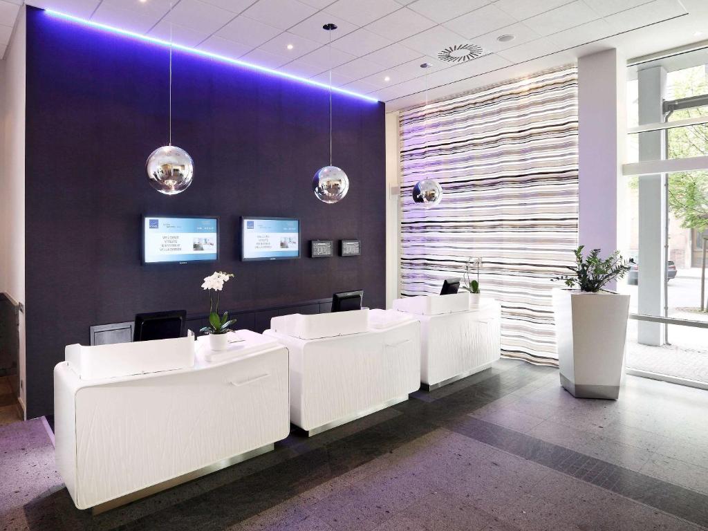 an office with white desks and a purple wall at Novotel Praha Wenceslas Square in Prague