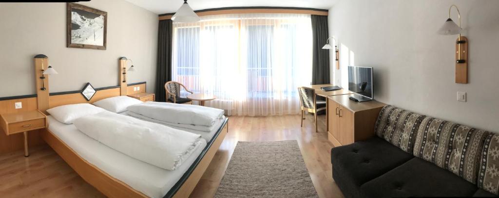 Postel nebo postele na pokoji v ubytování Hotel Garni Aurora