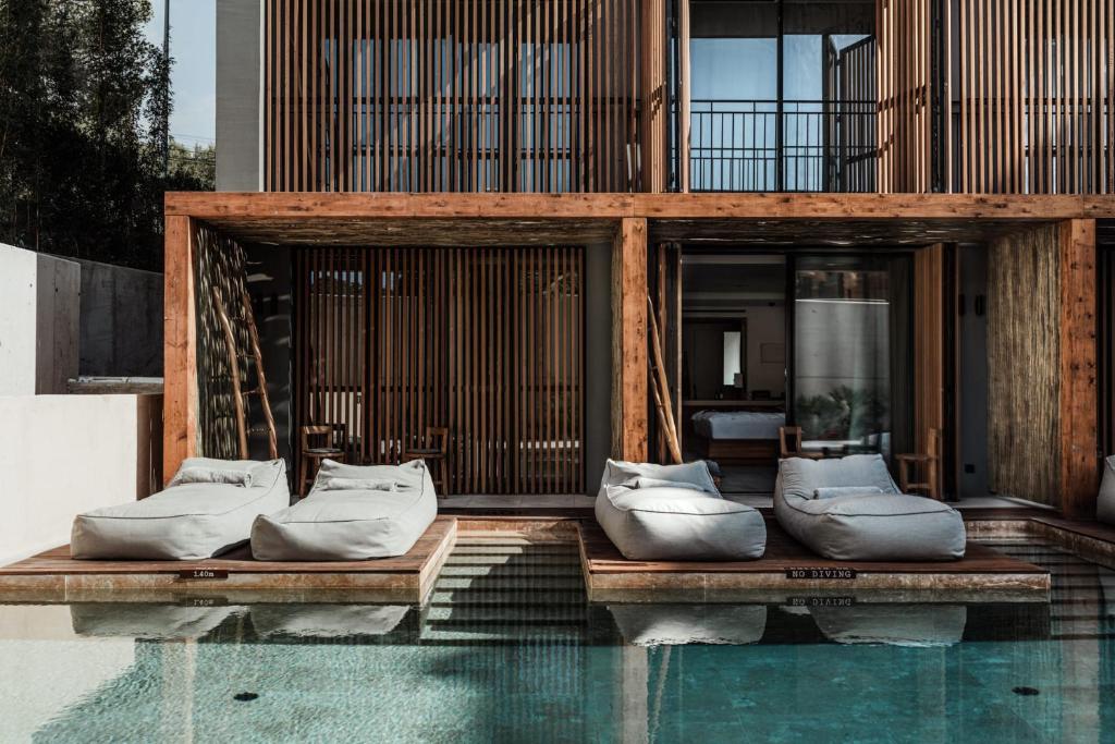 a building with pillows sitting on top of a pool at OKU Ibiza in San Antonio