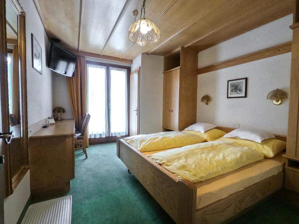 Postel nebo postele na pokoji v ubytování Garni Soldanella