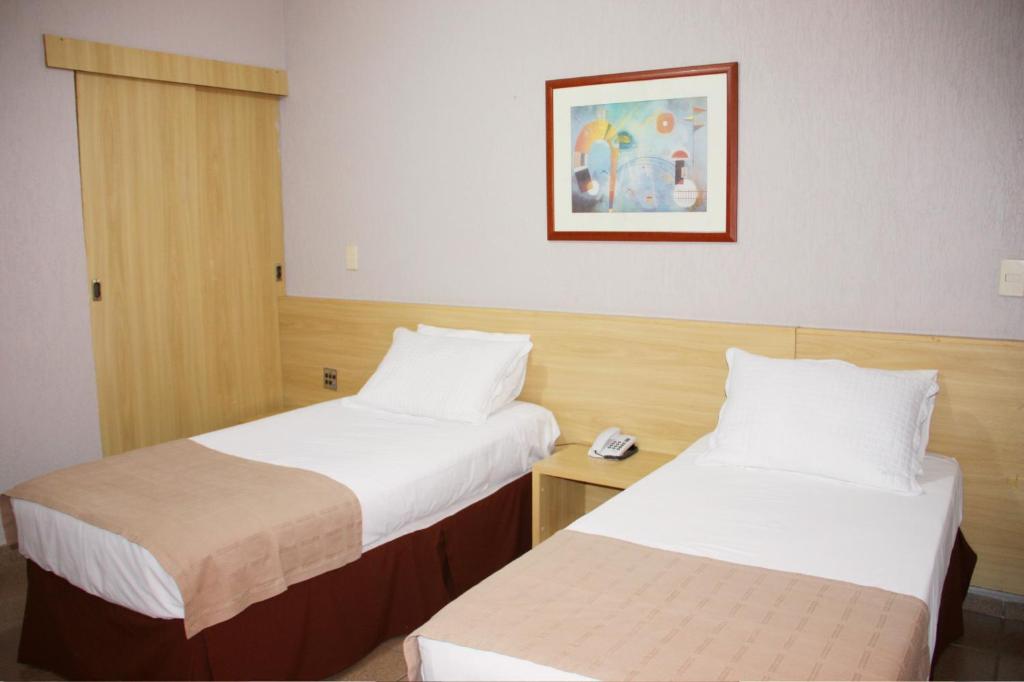 Postel nebo postele na pokoji v ubytování Hotel Foz do Iguaçu