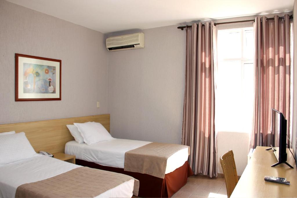 Postel nebo postele na pokoji v ubytování Hotel Foz do Iguaçu