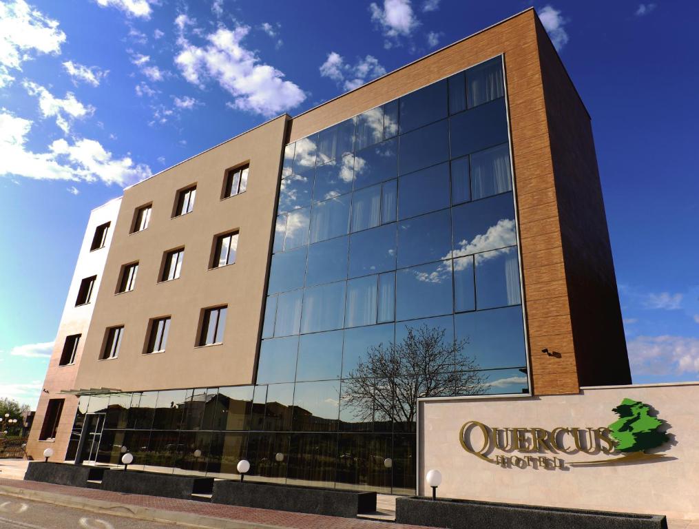 a building with a sign in front of it at Hotel Quercus in Međugorje