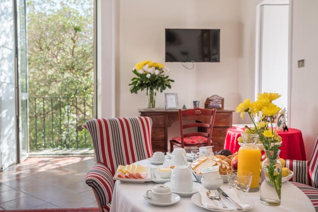a dining room with a table with food on it at Palazzo Bernardini Suites in Lecce