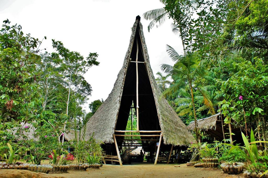 a small hut in the middle of a forest at Reserva Natural Tanimboca in Leticia