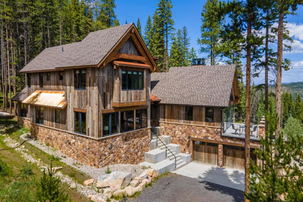 an exterior view of a log home with a roof at Custom Ski In Ski Out Luxury Chalet - Hot Tub & Amazing Views - 500 Dollars Of FREE Activities & Equipment Rentals Daily in Winter Park